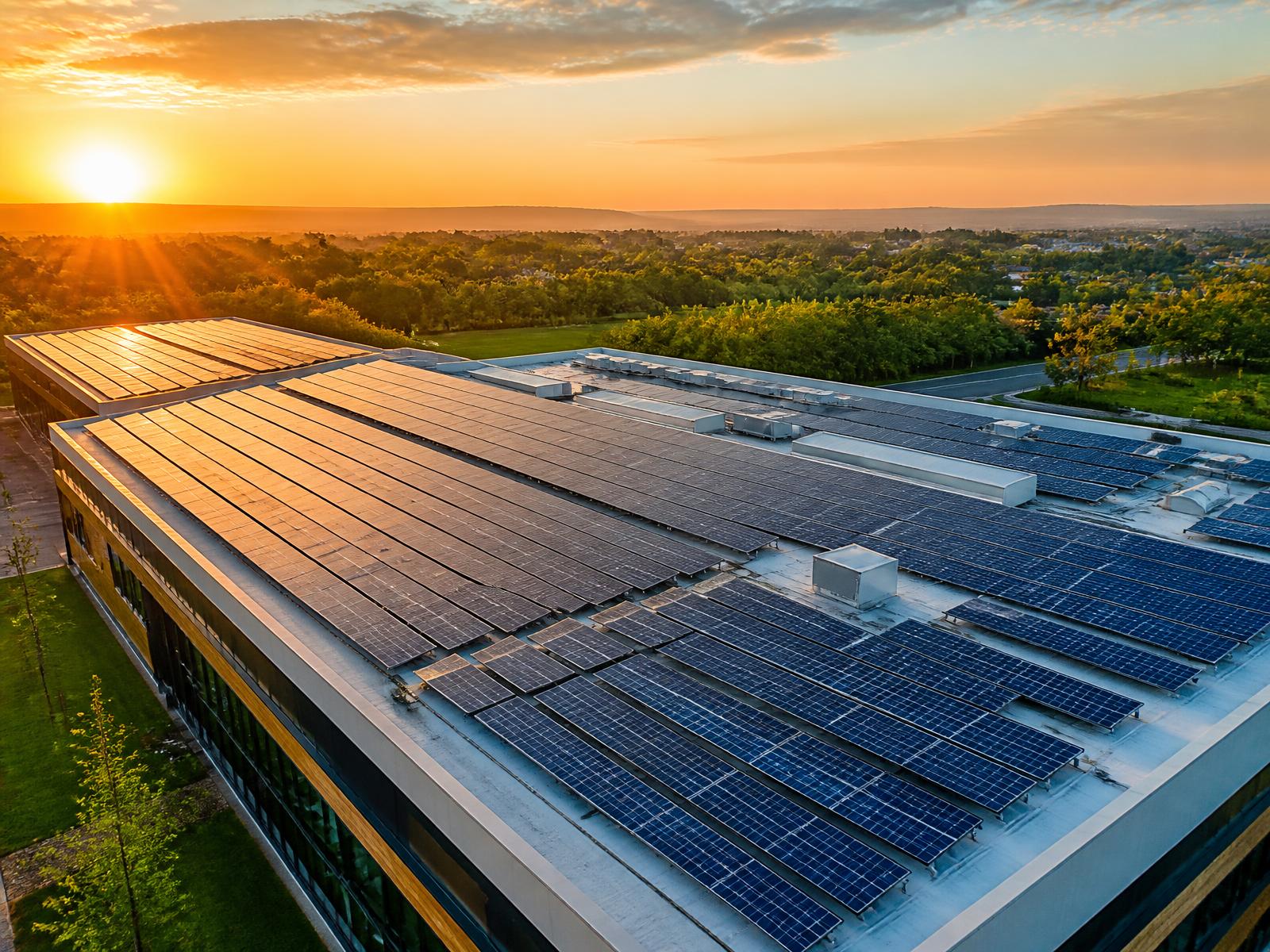 Commercial solar array extending across an industrial rooftop
